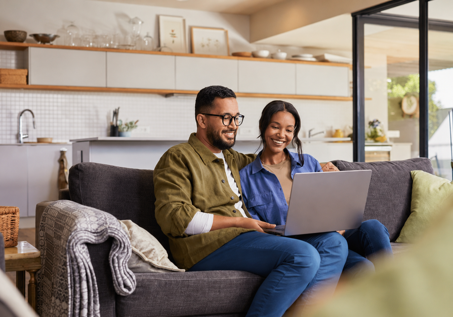 Couple at home connecting with their care team on a laptop